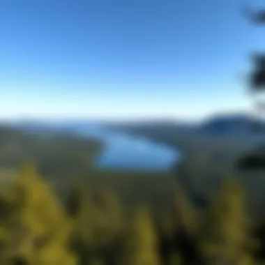 Breathtaking vista overlooking a tranquil lake framed by rugged hills under a clear blue sky